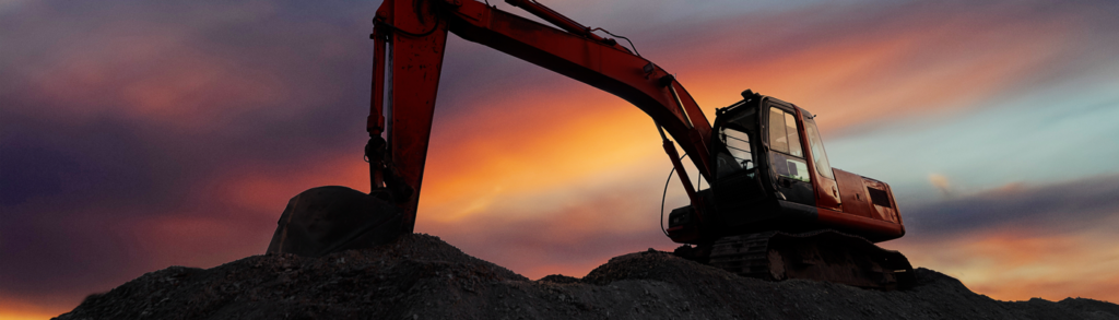 mining machinery in front of a sunset